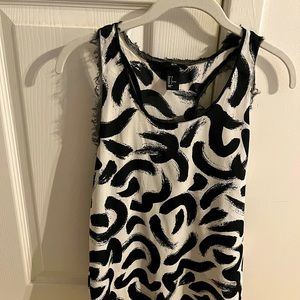 Black and white sleeveless top.